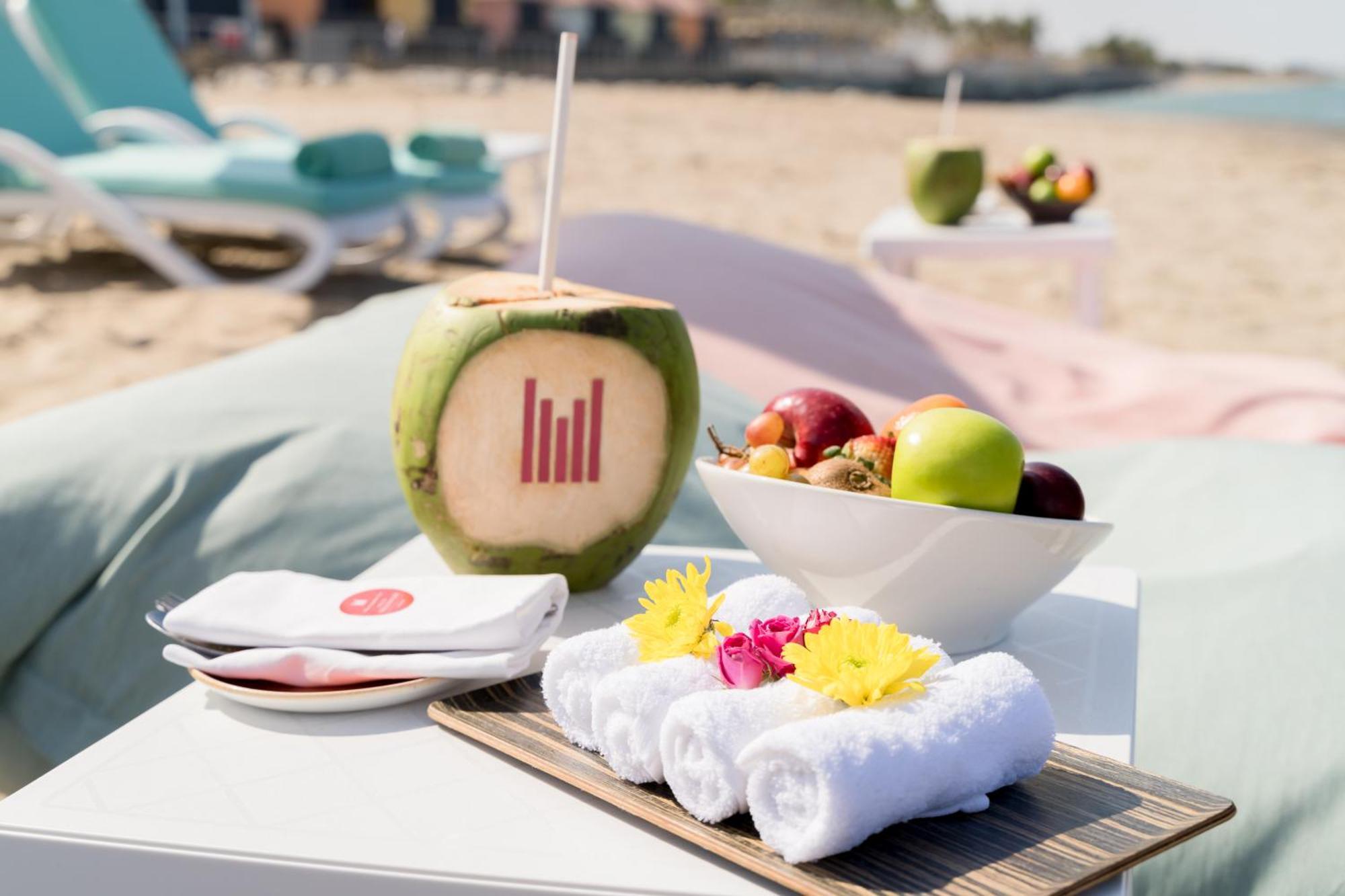 Grand Millennium Muscat Hotel Exterior foto A coconut drink at the beach